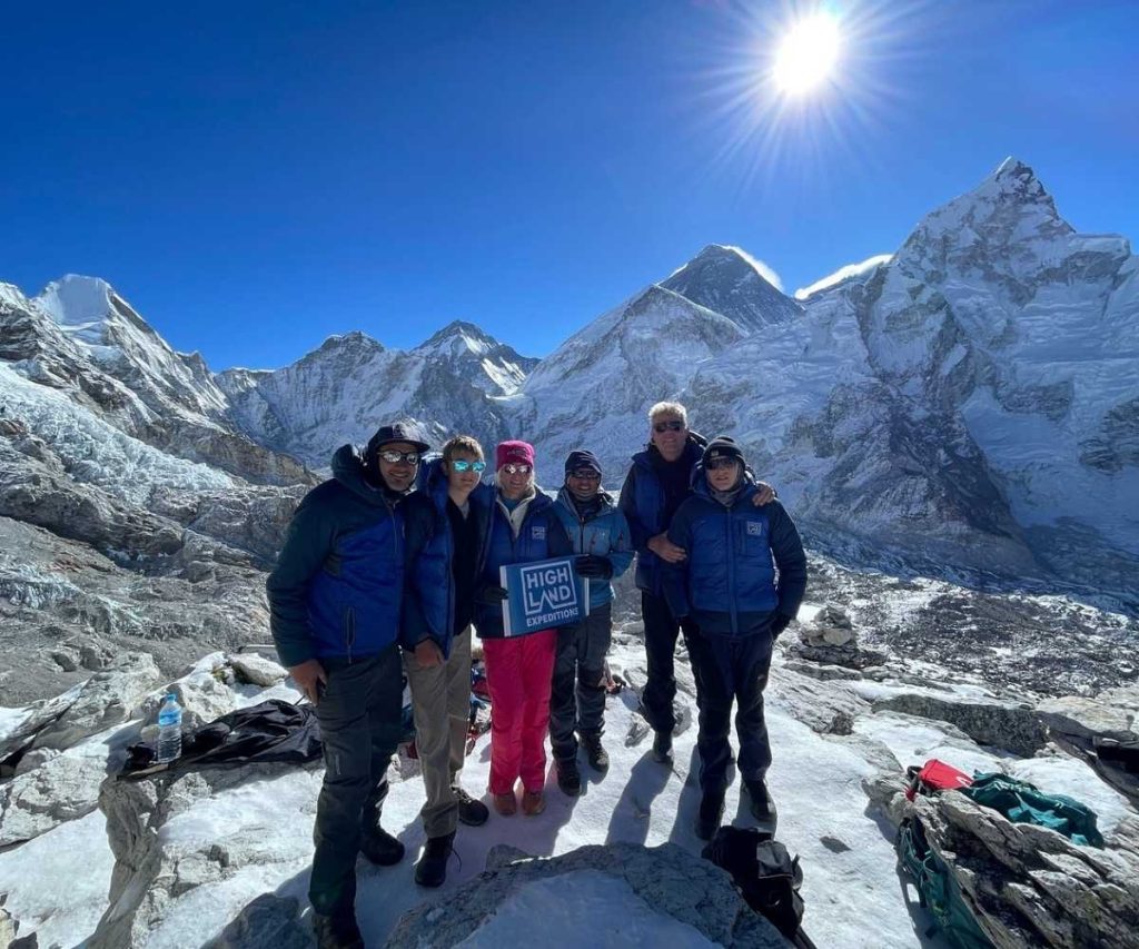 Trekkers on Kala Patthar on a clear morning with Mount Everest in the background
